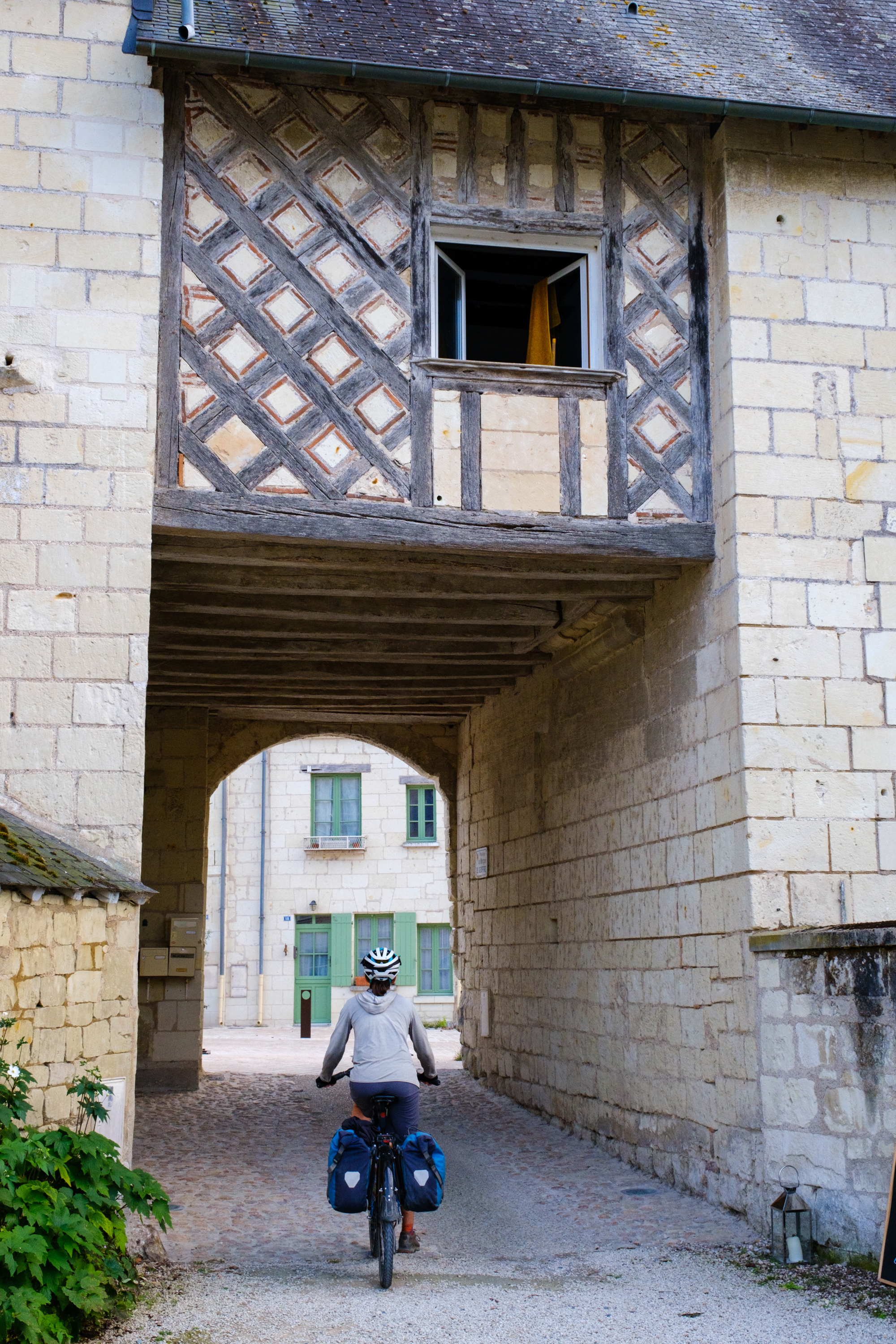 cycling underneath a raised walkway in saumur